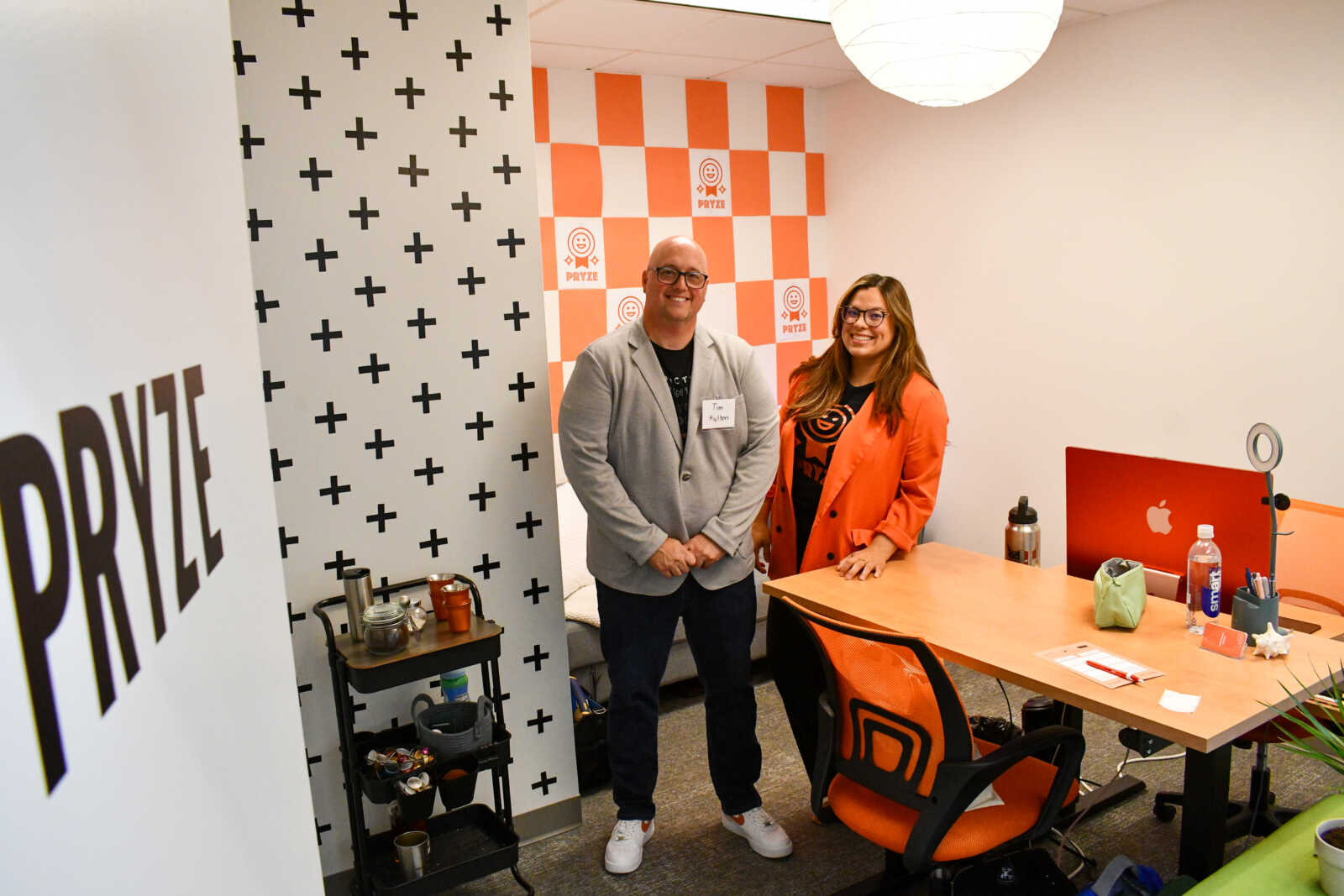 The Pryze team inside their orange and black workspace with Unstuck Labs